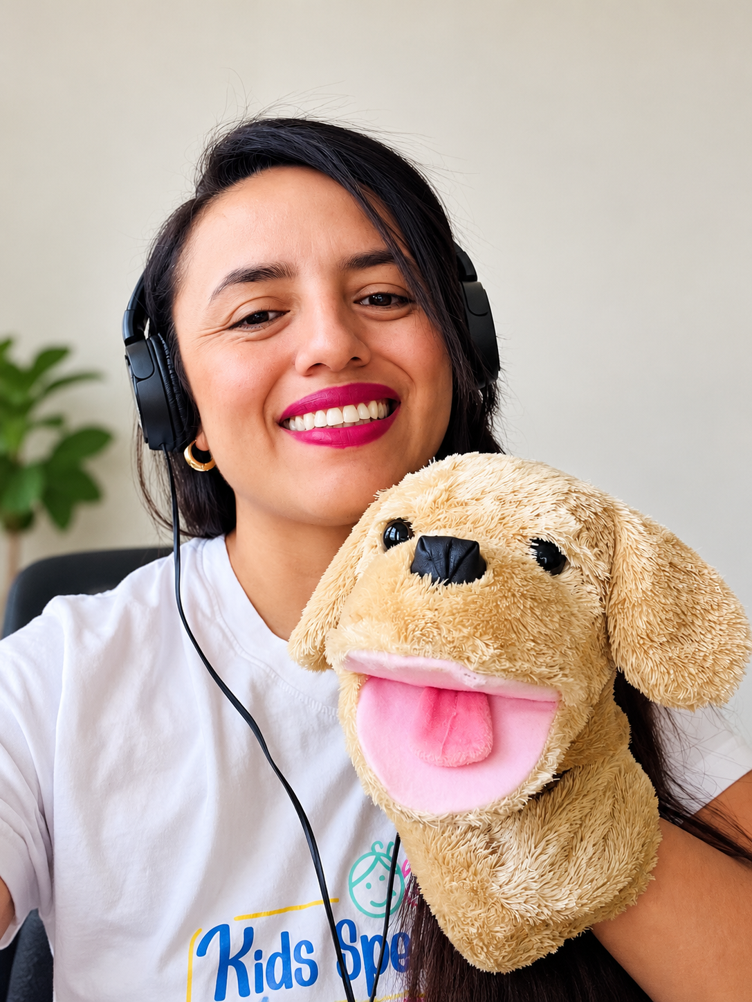 Viviana, founder of Kids Spanish Zone, smiling with headphones and a puppy puppet
